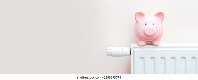 Radiator at home, the concept of rising heating prices. Piggy bank with a scarf sits on a radiator - Powered by Shutterstock