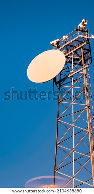 Radio\
antenna tower on blue sky background for cellphone or smartphone\
backdrop image with space for texts and\
design.