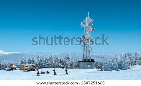 Radio antennae and microwave dishes covered in snow and ice at the summit of Mount Yokoteyama in Nagano, Japan