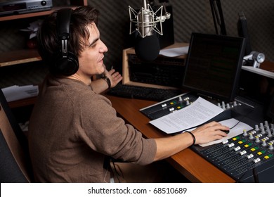 Radio DJ. Young Man With Microphone And Headphone.