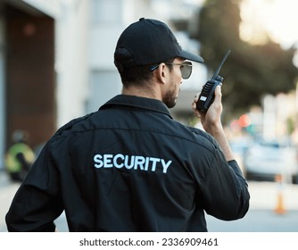 Radio, man and a security guard or safety officer outdoor on a city road for communication. Back of a person with a walkie talkie on urban street to report crime for investigation and surveillance - Powered by Shutterstock