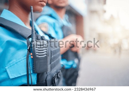Radio, police and surveillance with a black woman officer standing outside while on patrol in the city. Walkie talkie, dispatch or communication with a female security guard in an urban town