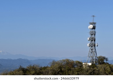 A radio tower stands at the top of a mountain  - Powered by Shutterstock