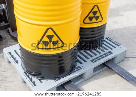 Radioactive industry. Barrels with radiation symbol close up. Containers with radioactive hazard symbol. Concept of toxic industry waste storage. Transportation of radioactive substances on forklift