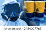 Radioactive safety. Man in radiation protection suit. Nuclear leak danger symbol on barrels. Containers with radioactive fuel on forklift. Barrels with uranium. Radioactive waste. Person in gas mask