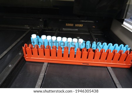 Radioactive samples in plastic capped vials, loaded to be read by a liquid scintillation counter                               