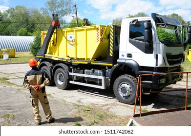 Radioactive Waste Storage Container Loading On A Truck Crane, Worker Watching