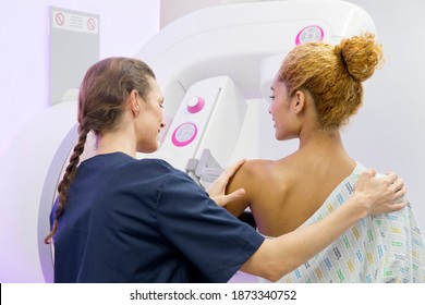 Radiographer guiding a Patient at the mammogram system