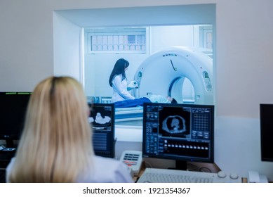 Radiologist in the control room of computed tomography at hospital - Powered by Shutterstock