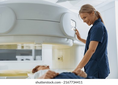 Radiologist controls MRI or CT Scan with patient undergoing procedure. High Tech medical equipment - Powered by Shutterstock