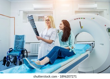 Radiologist With A Female Patient Examining A CT Scan