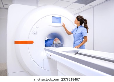 Radiologist preparing MRI or CT scan machine for senior patient at hospital. - Powered by Shutterstock