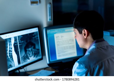 Radiologist Sitting At Computer In Office. X-ray Picture On Screen. Healyj Care Concept.