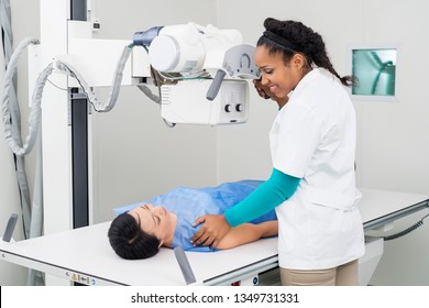 Radiologist Taking X-ray Of Mature Patient Lying On Gurney
