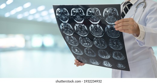 radiology doctor examines film x-ray brain by ct scan mri of the patient.