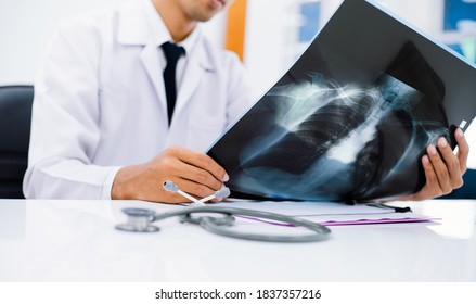 Radiology Doctor Examining At Chest X Ray Film Of Patient At Health Care Clinic