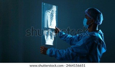 radiology doctor examining at chest x ray film of patient at hospital room.