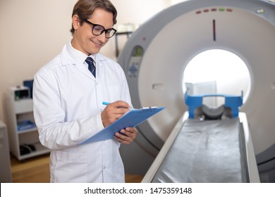 Radiology Technologist Filling Up Medical Form Stock Photo