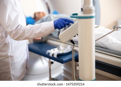 Radiology Technologist Performing CT Scanning At Hospital Stock Photo