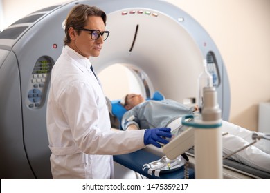 Radiology Technologist Using CT Scanner Stock Photo