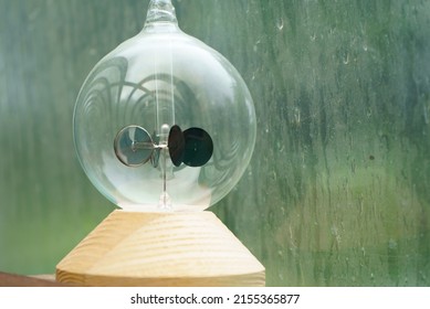 Radiometer On A Window Sill On A Rainy Day