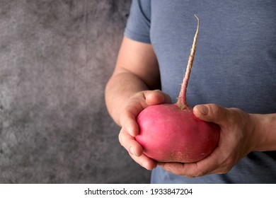 Radish In Strong Male Hands On A Gray Background. Funny, Abnormal Vegetable Or Food Waste Concept. Horizontal Orientation. Organic Food. Proper Nutrition
A Keto Diet Meal.

 