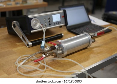 Radon Gas Radiation Detectors Testing. Dosimetrist Holding A Portable Gamma Radiation Dosimeter Set On A Long Tube With Sample Probe .