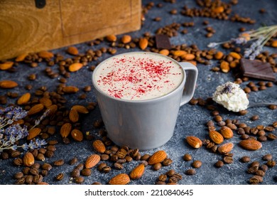 Raf coffee with raspberry on cup on grey table