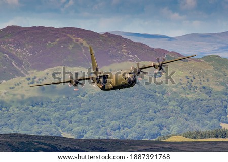 RAF Green Lockheed C-130 Hercules flying at Low level in the United Kingdom. 