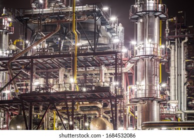 Rafinery In The Night. Chemical Industry Equipment - Fractionating Column With Pipes