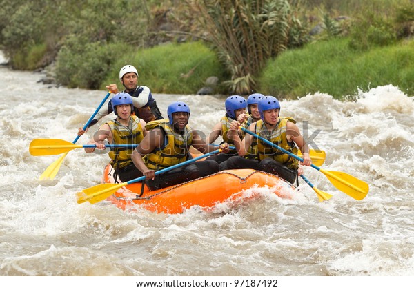 raft water white river sport adventure rowing\
whitewater group team community of mixed mountaineer male and women\
with guided by professional pilot on whitewater river rafting in\
ecuador raft water wh