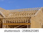 rafters of a new plywood house frame wood truss real walls