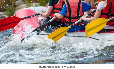 Rafting. Close-up View Of Oars With Splashing Water