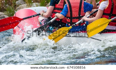 Rafting. Close-up view of oars with splashing water