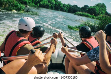  Rafting team , summer extreme water sport.  Group of people in a rafting boat, beautiful adrenaline ride down the River. Back view. POV