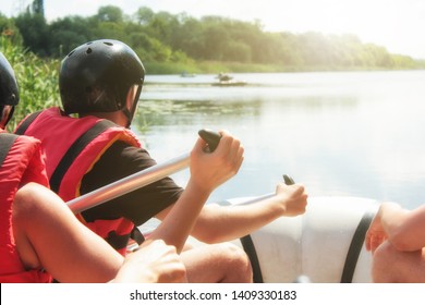  Rafting Team , Summer Extreme Water Sport.  Group Of People In A Rafting Boat, Beautiful Adrenaline Ride Down The River. Back View. POV