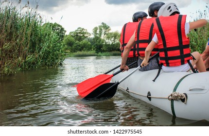  Rafting Team , Summer Extreme Water Sport.  Group Of People In A Rafting Boat, Beautiful Adrenaline Ride Down The River. Back View. POV