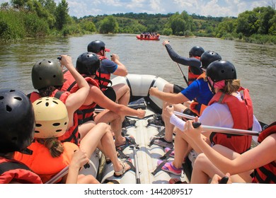 Rafting Team , Summer Extreme Water Sport.  Group Of People In A Rafting Boat, Beautiful Adrenaline Ride Down The River. Back View. POV