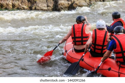 Rafting Team , Summer Extreme Water Sport.  Group Of People In A Rafting Boat, Beautiful Adrenaline Ride Down The River. Back View. POV