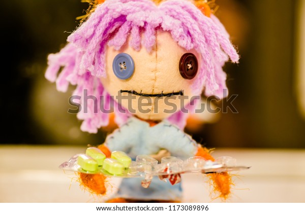 doll with pink hair and button eyes