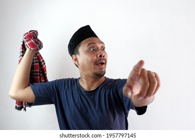 rage asian man pointing finger and trying to hit someone using sarong cloth in his hand