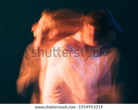 Rage man. Bipolar disorder. Psychology stress. Toxic relationship. Conceptual art portrait. Surreal aggressive screaming guy reflecting each other isolated green blur light double exposure.