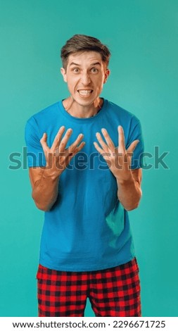 Rage man. Overwhelming aggression. Emotional angry guy clenched teeth expressing hate anger isolated on turquoise empty space background.