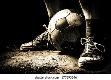 Ragged sneakers with a soccer ball