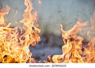 Raging flames of huge fire. Firestorm close up. Burning fire full frame image. Bright inferno flames. Hell fire explosion. Blaze fire texture. Burning bright Bonfire. Intense combustion and heat.