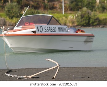 Raglan New Zealand - June 7 2008; Small Boat Near Waters Edge With Sign Advocating No Seabed Mining