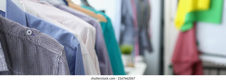 Rail with hanging of set with different colours mens shirts - Powered by Shutterstock