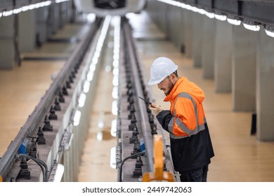 Rail maintenance engineer assessing condition of infrastructure. Planning and executing upgrades to rail system that reduce co2 footprint, enhance energy efficiency, focusing on sustainable practices