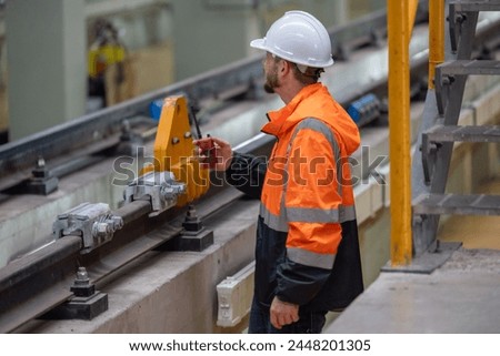Rail maintenance engineer assessing condition of infrastructure. Planning and executing upgrades to rail system that reduce co2 footprint, enhance energy efficiency, focusing on sustainable practices