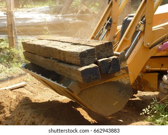 Rail Road Ties Carried By Yellow Machine